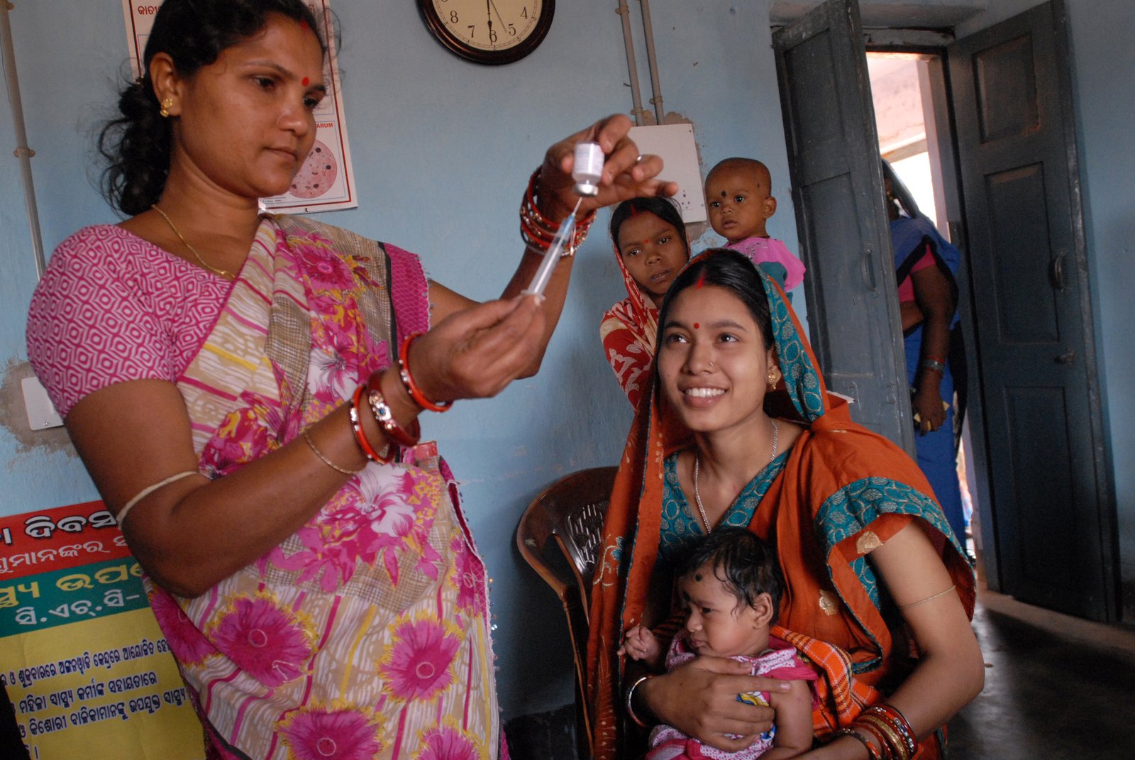 A community health worker meeting with families